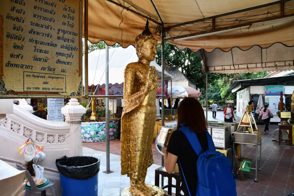 仏像に金箔を貼るタイのお参り